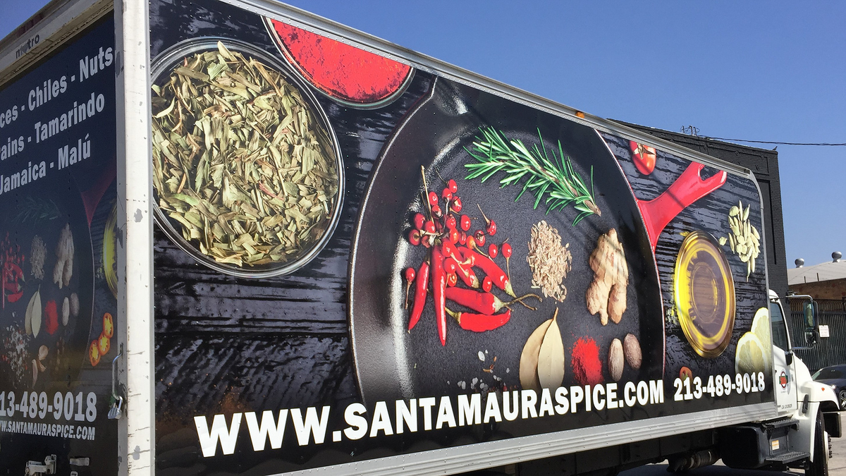 Santa Maura delivery van with chiles and spices on its side